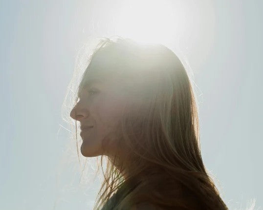 Side profile of a person with a blurred background