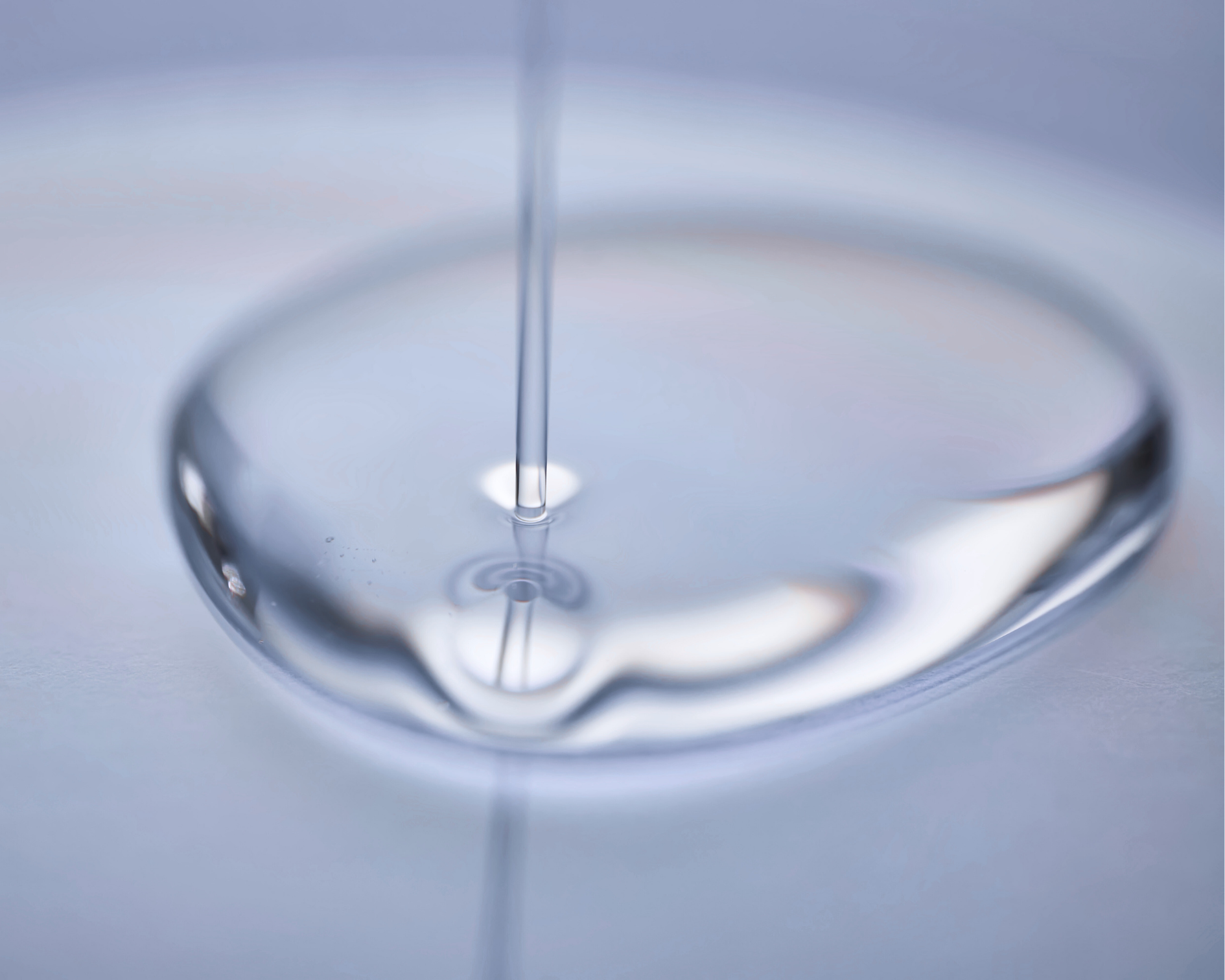 Close-up of a droplet of water on a reflective surface